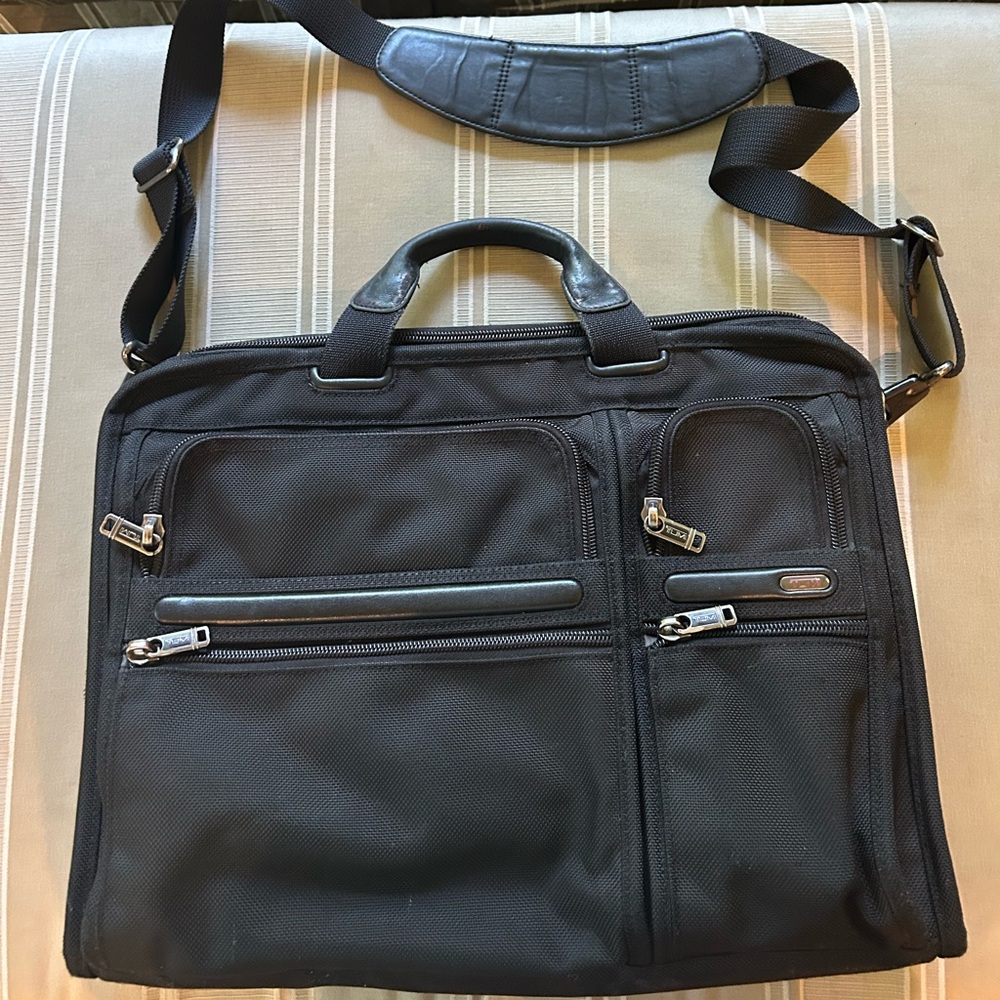 Tumi Black Briefcase with Adjustable Straps and Multiple Compartments